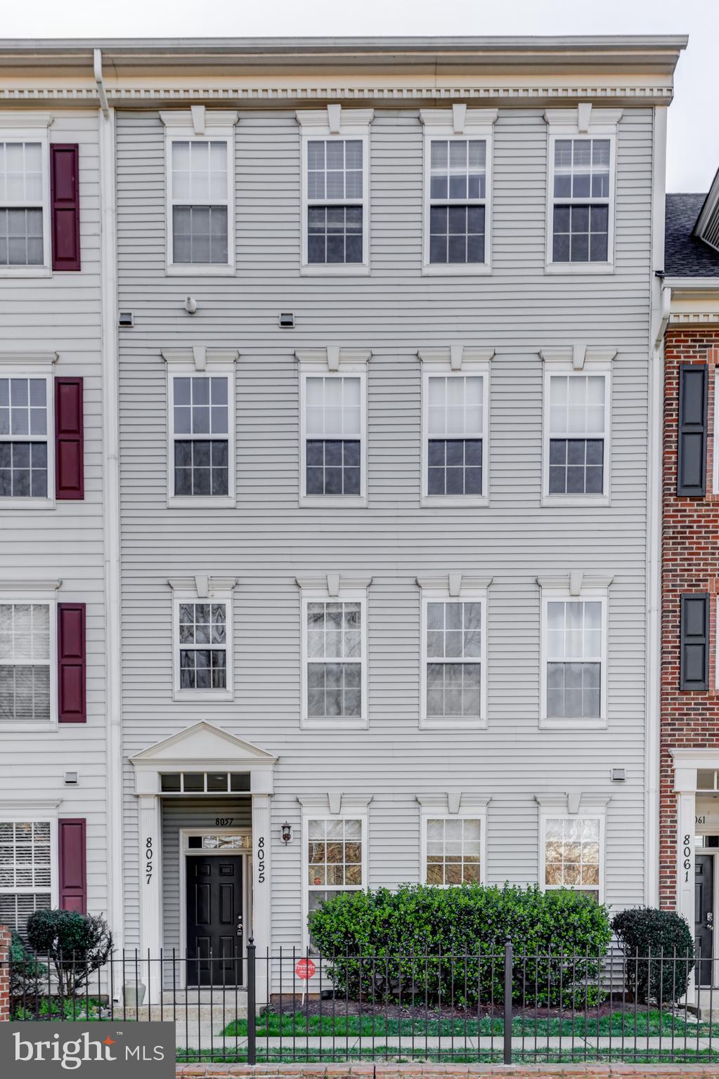 a front view of a building with a yard