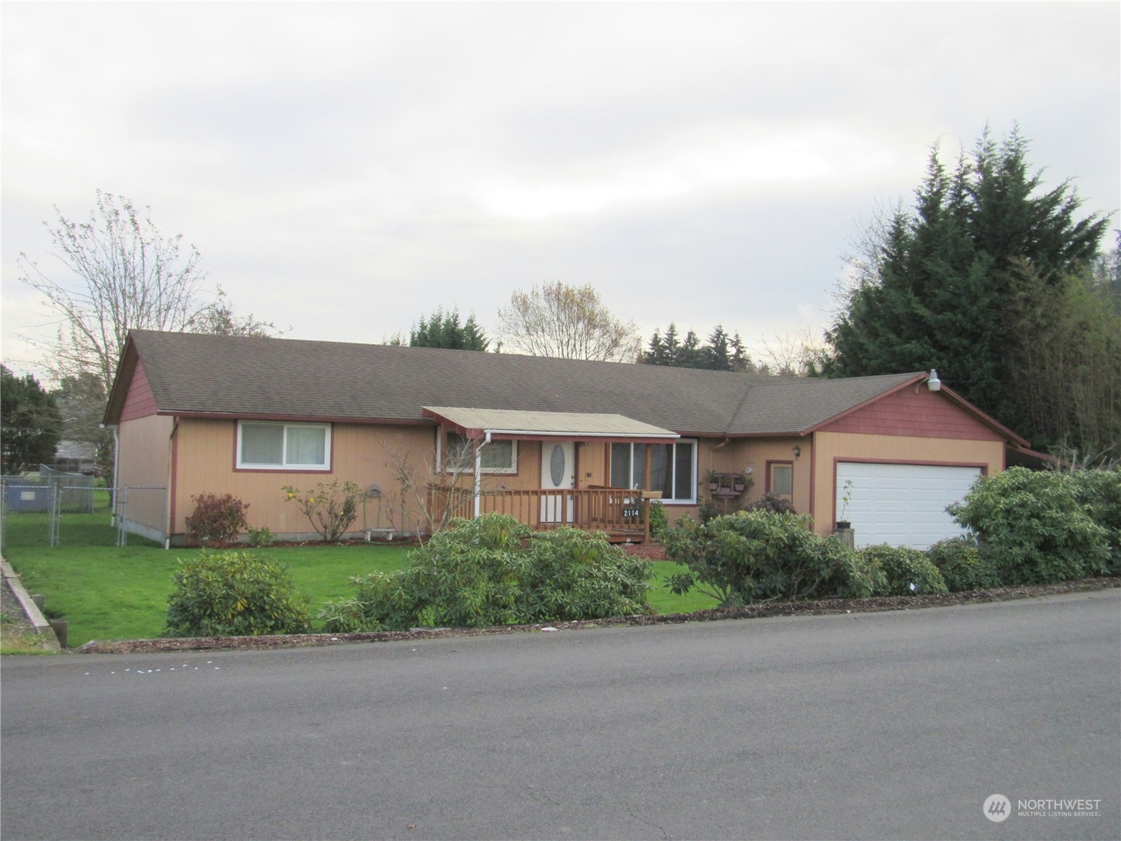 a front view of a house with a yard and a garage