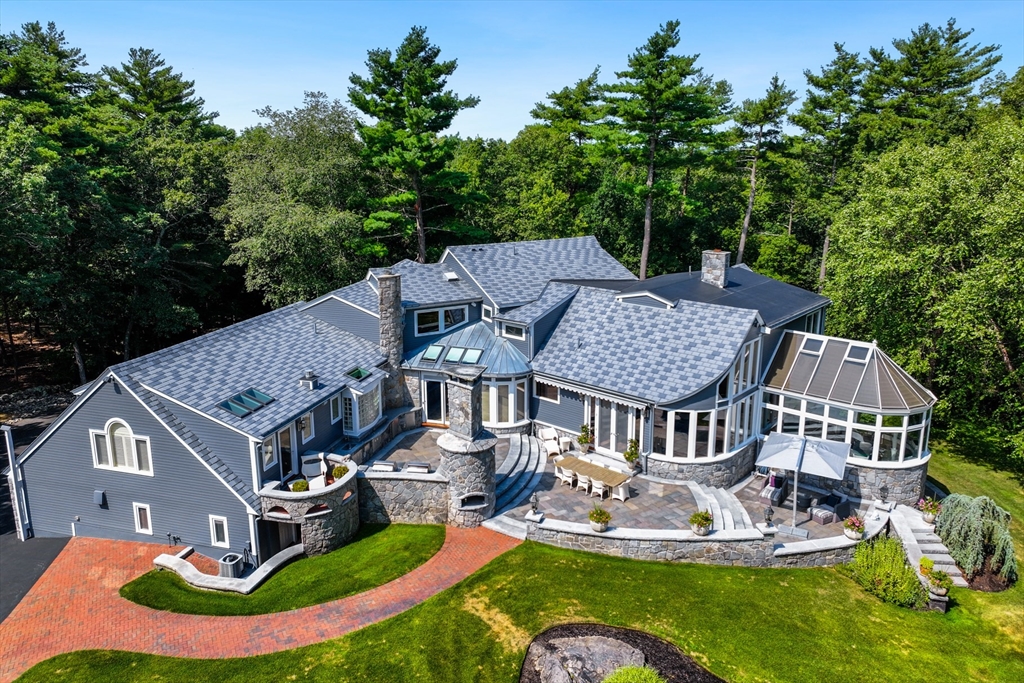 an aerial view of a house with swimming pool and big yard