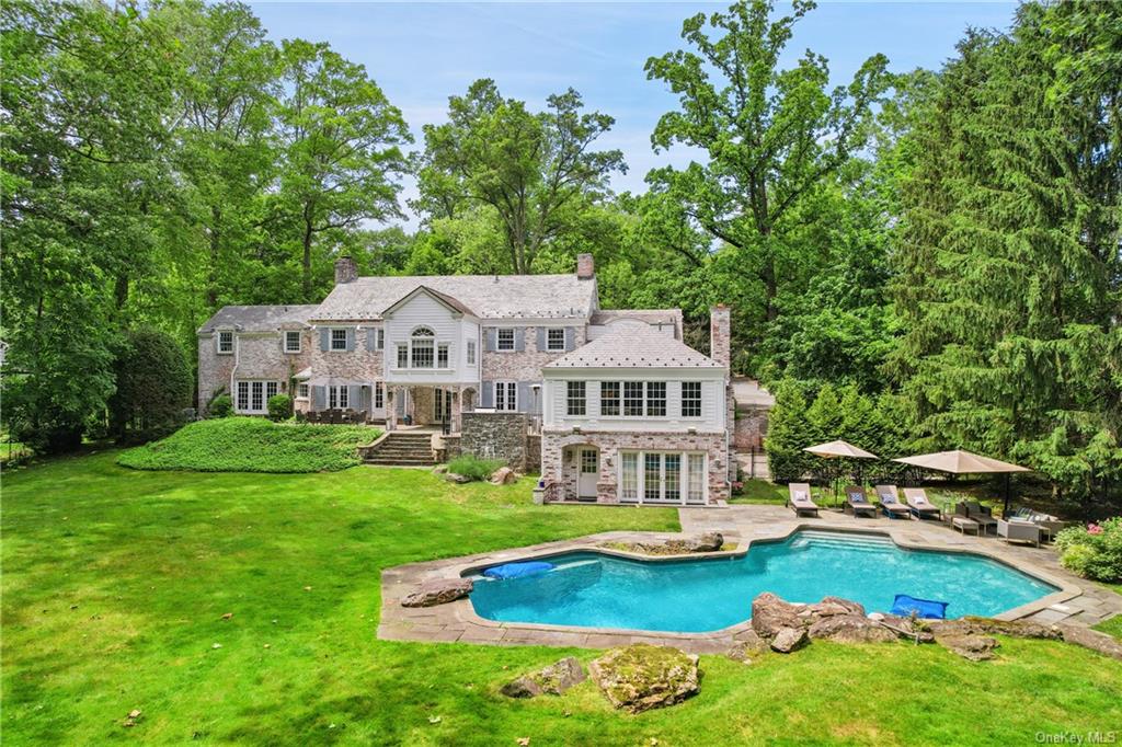 a view of a house with swimming pool and a yard