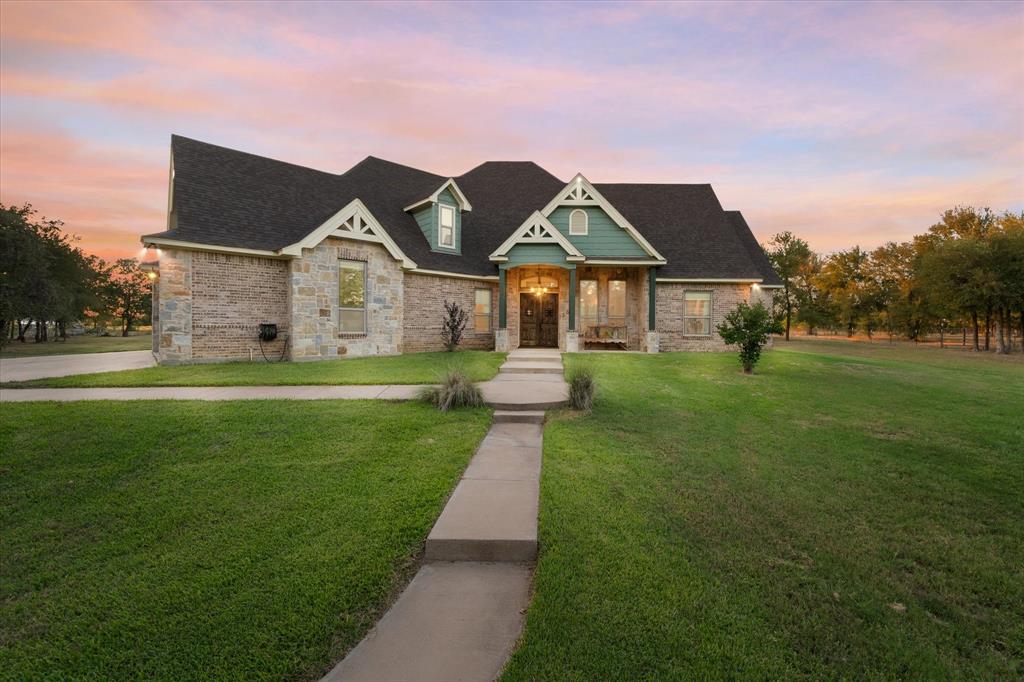 a front view of a house with a yard