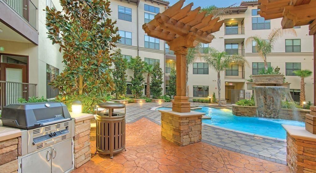 a view of a patio with table and chairs