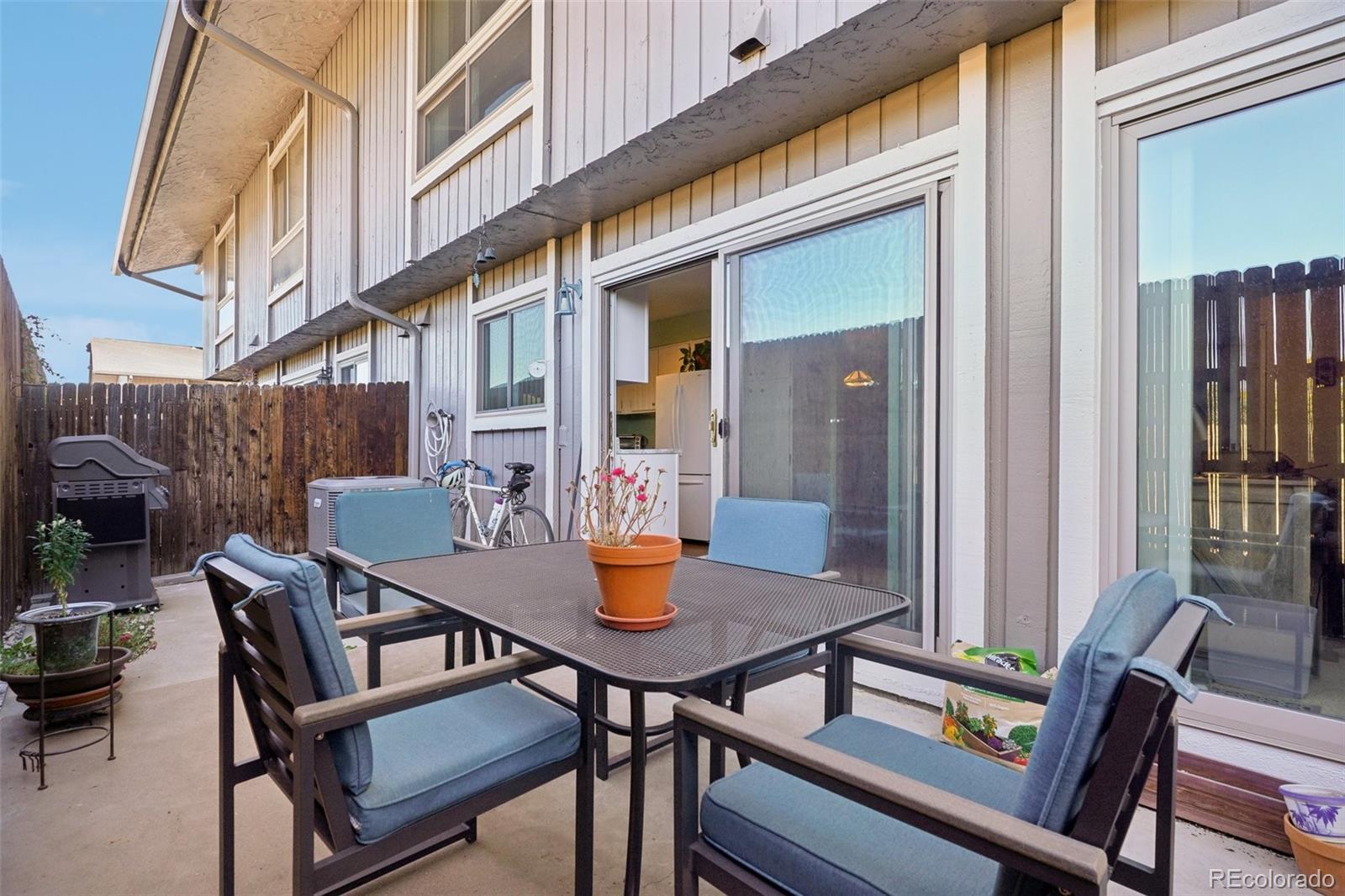 a view of a house with backyard and sitting area