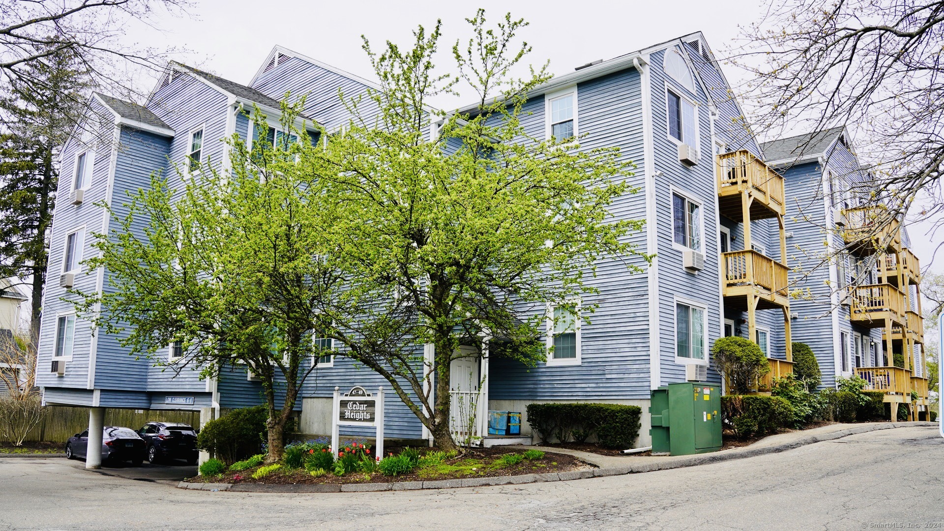 a front view of a building with trees