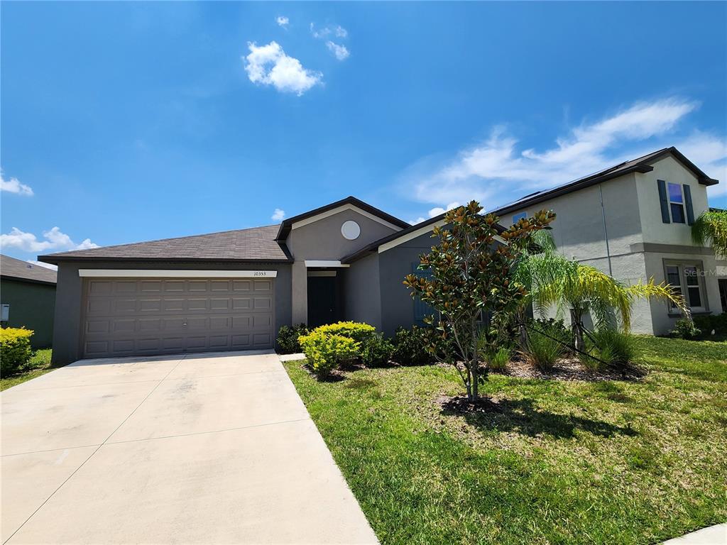 a front view of a house with a yard and garage