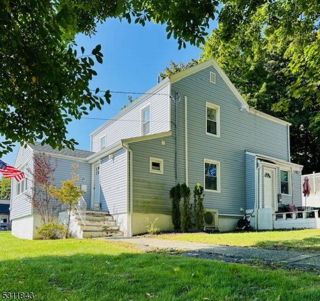 a front view of house with yard and swimming pool