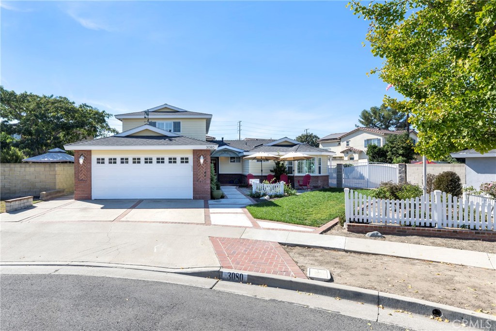 a view of a house with a yard and fence