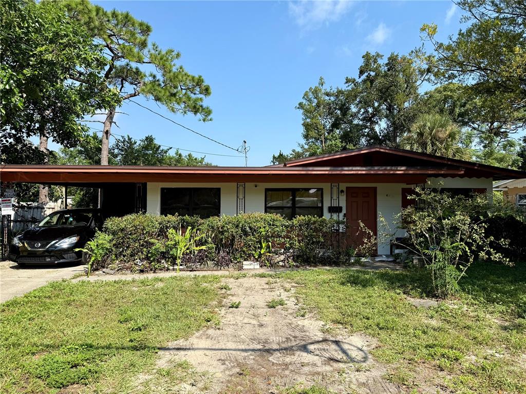 a front view of house with yard and green space