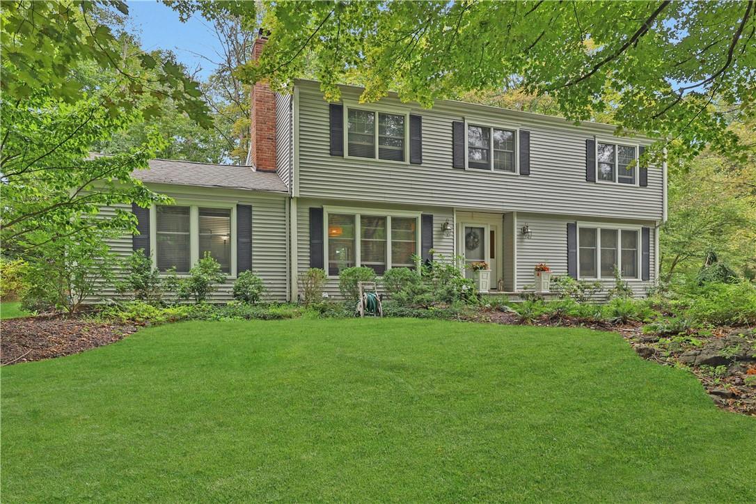 Colonial inspired home featuring a front yard