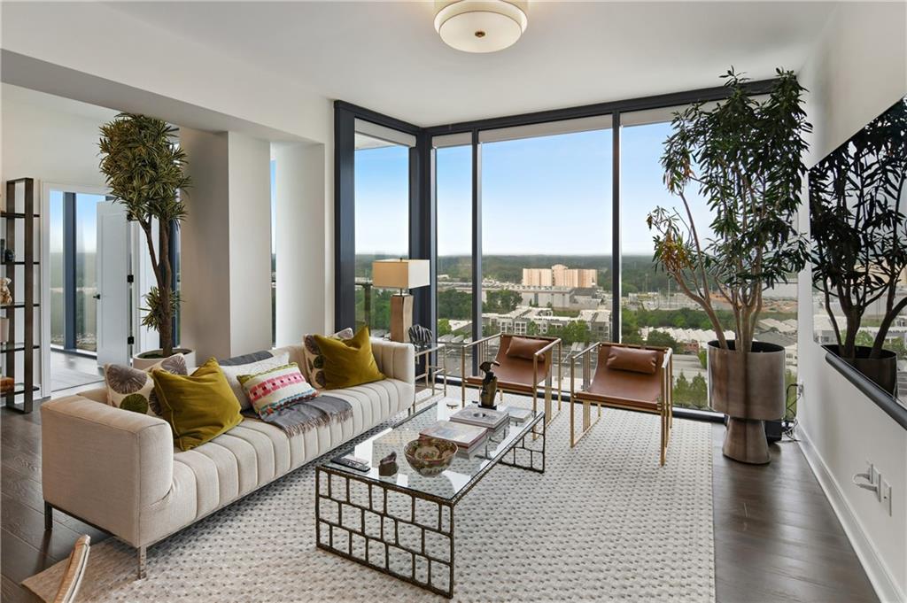 a living room with furniture and a large window