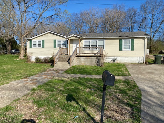 a front view of house with yard and green space