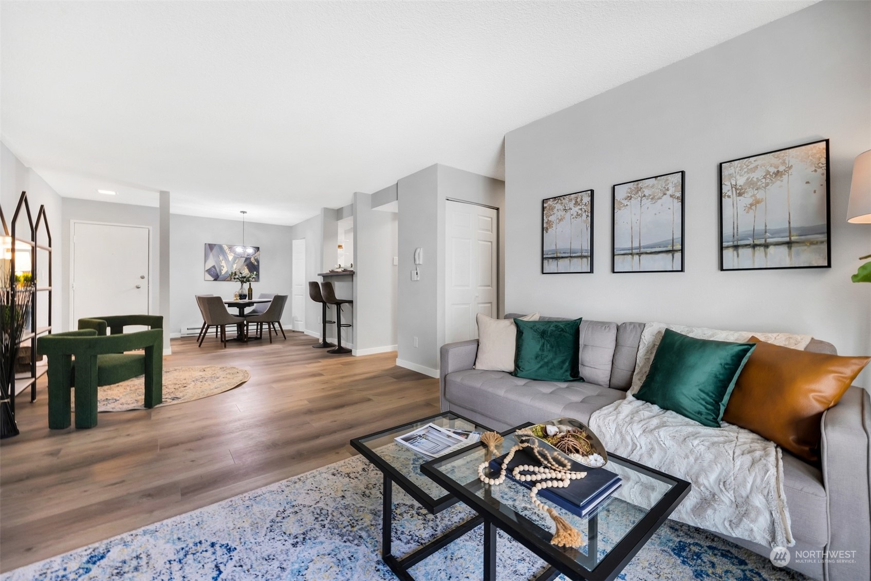 a living room with furniture and wooden floor