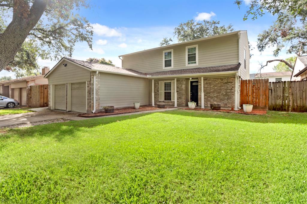 a front view of a house with a garden and yard