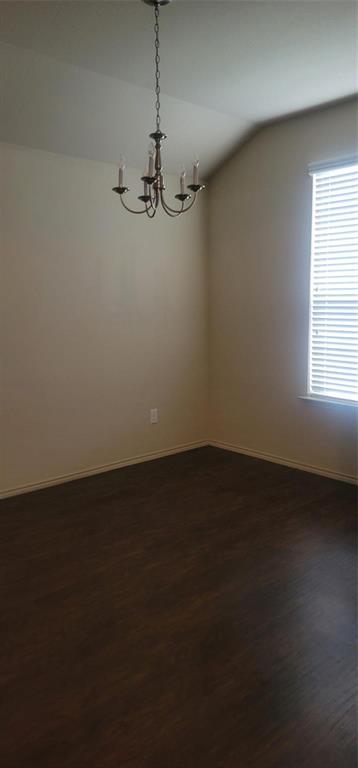 a view of a room with an empty space and a window