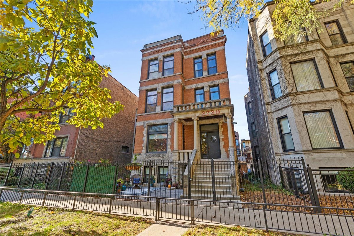 a view of a brick building next to a yard