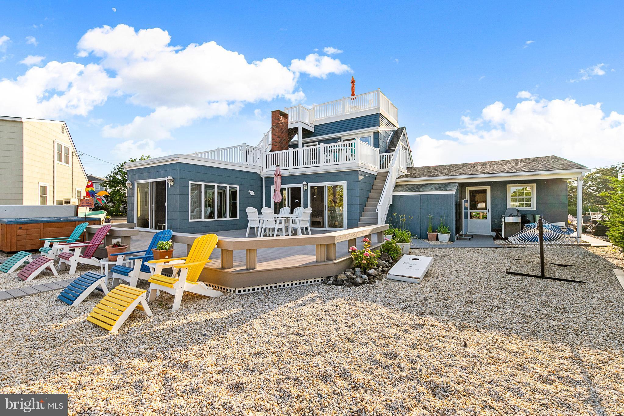 a view of a house with backyard porch and sitting area