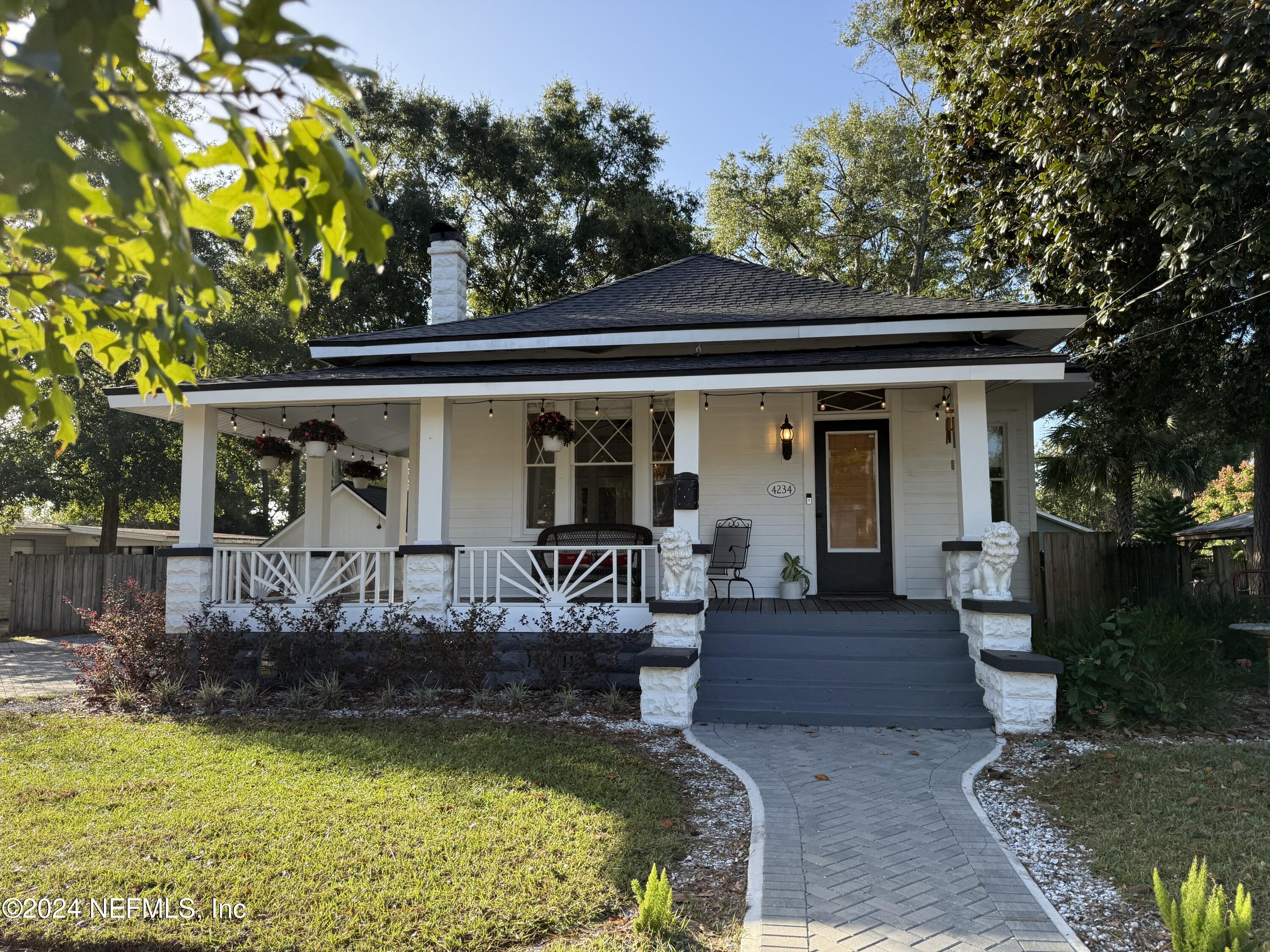 a view of house with swimming pool and outdoor seating