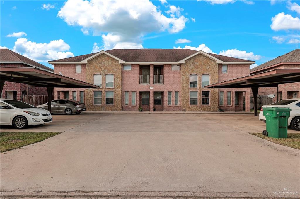 View of front of home with a balcony and a carport