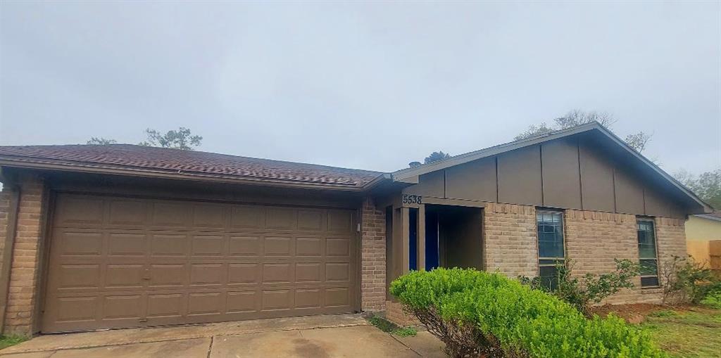 a front view of a house with garage