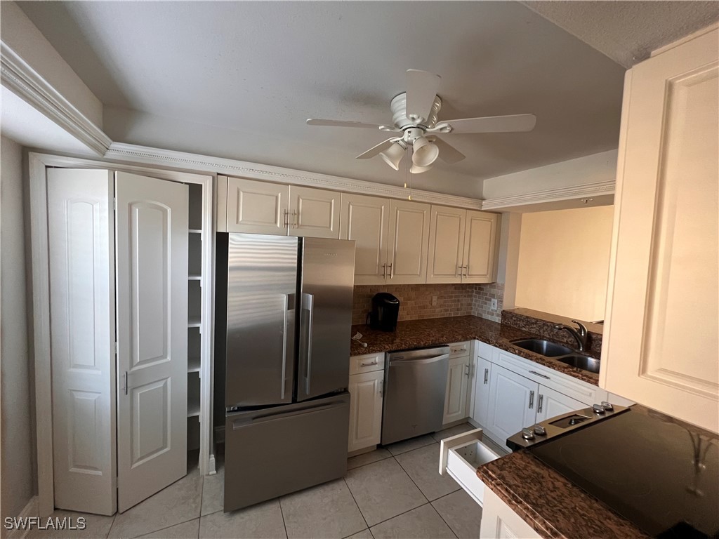 a kitchen with stainless steel appliances a refrigerator sink and cabinets