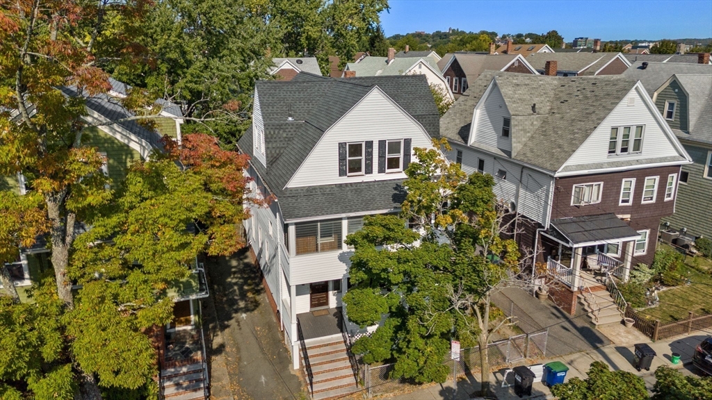 aerial view of a house with a yard and potted plants