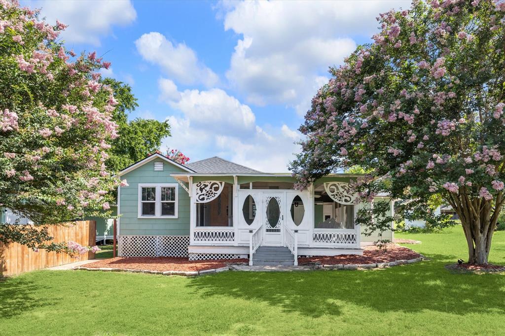 a front view of house with a garden