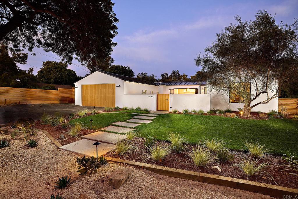 a front view of a house with garden