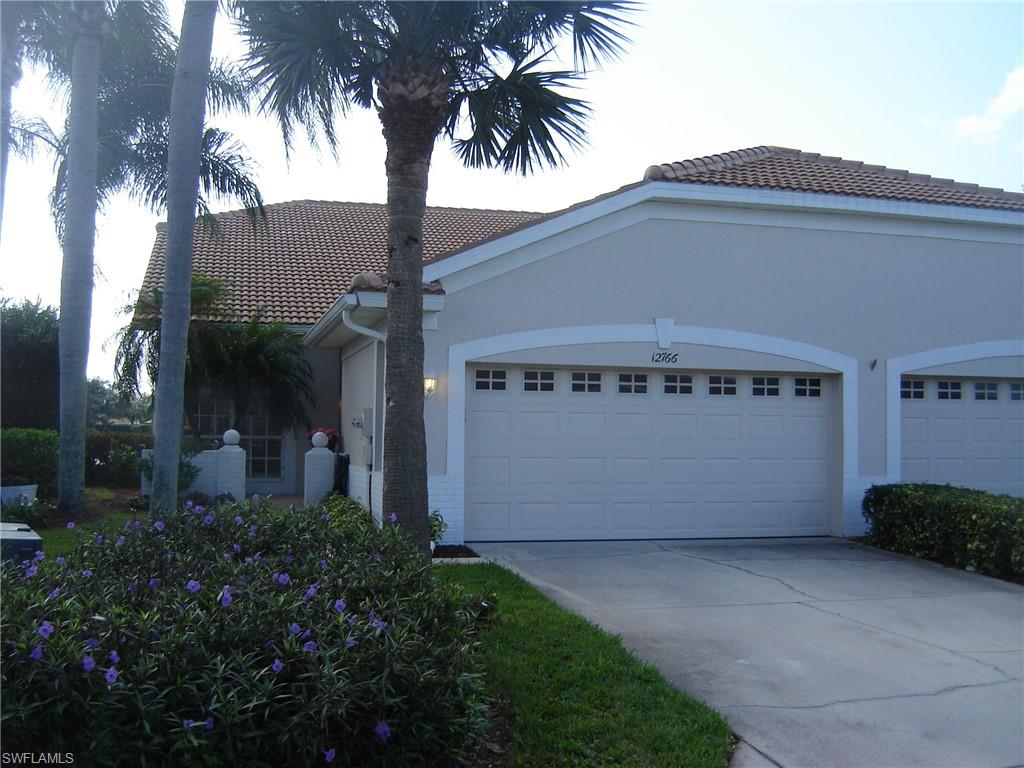 a front view of house with garage and garden