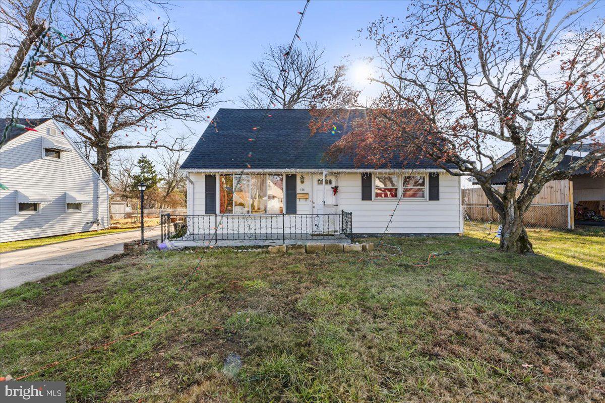 a view of a house with a yard and tree s