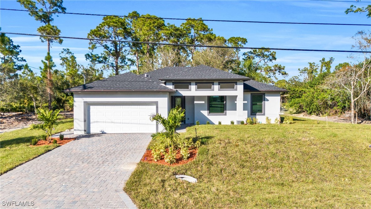 a front view of a house with a yard and garage