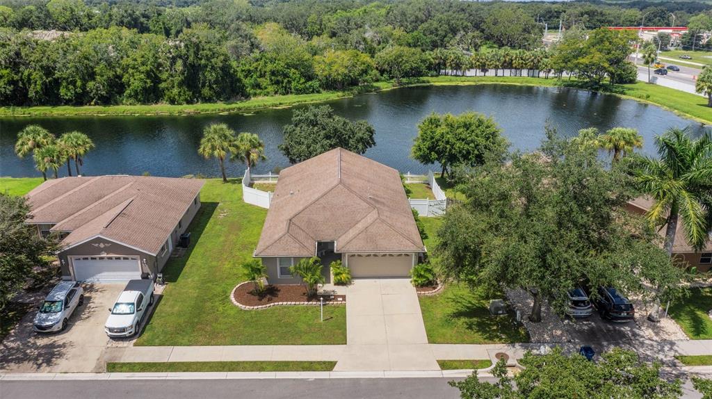 an aerial view of a house with outdoor space and lake view