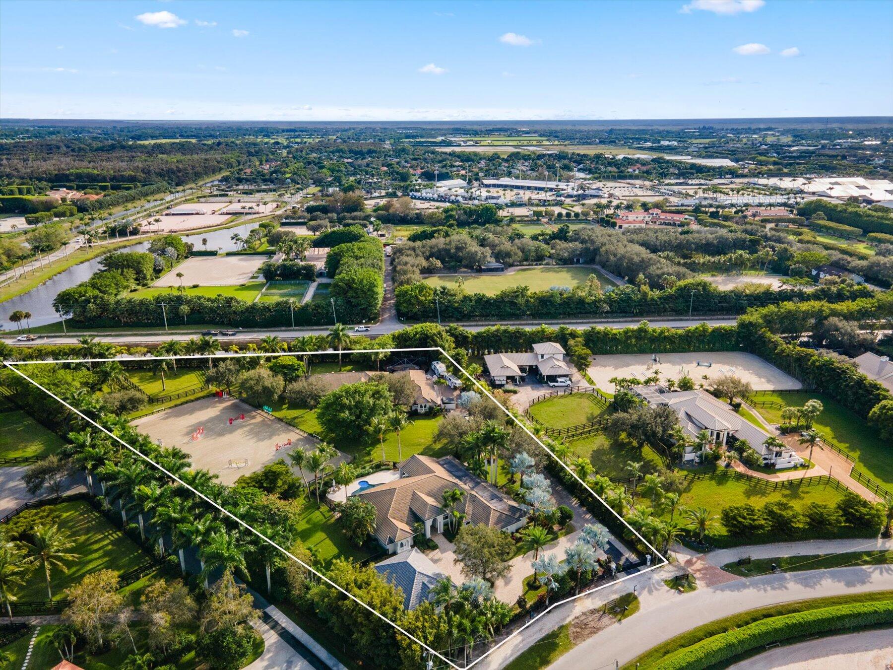 an aerial view of residential houses with outdoor space and lake view