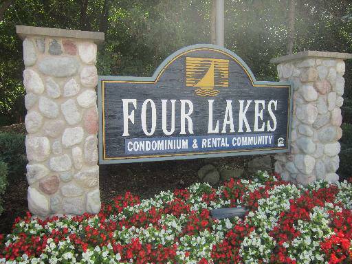 a view of sign board with flower plants