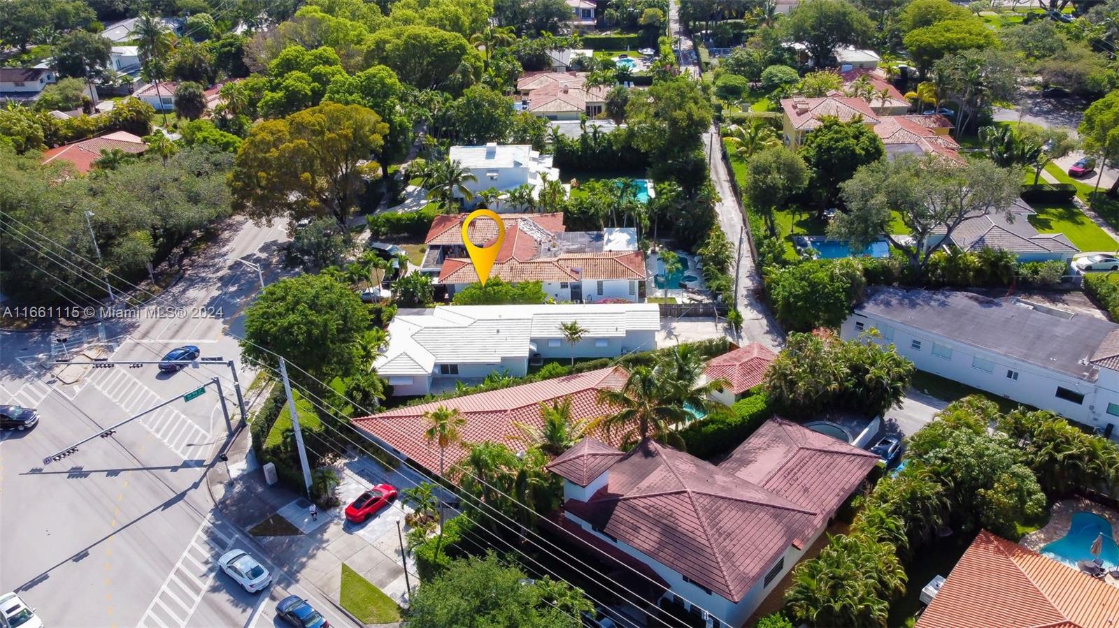 an aerial view of a house with a garden and lake view