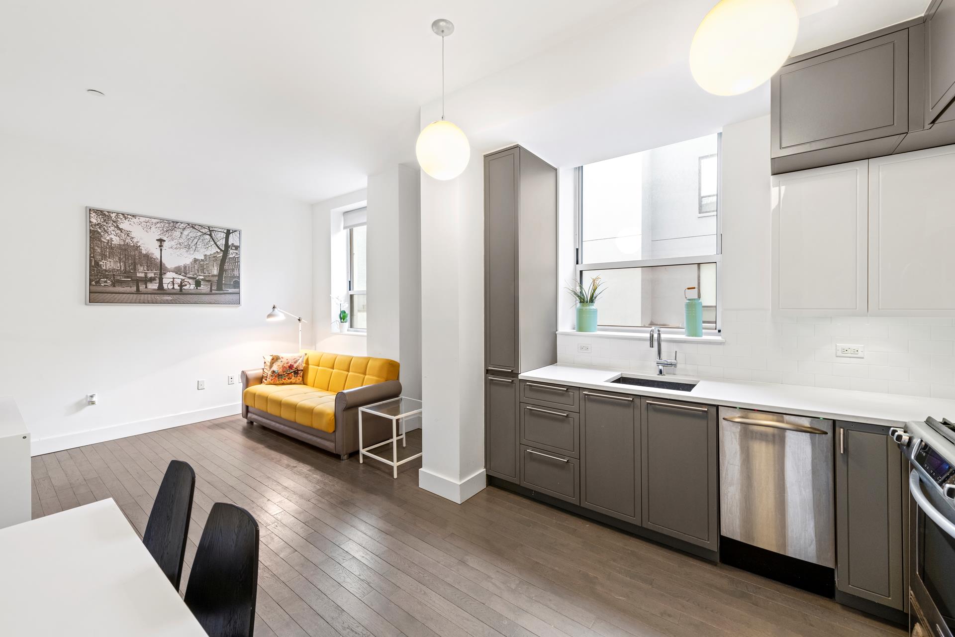 a view of kitchen with stainless steel appliances granite countertop a sink a stove a dining table and chairs