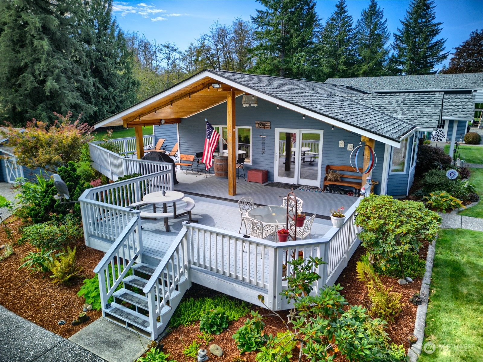 a front view of house with deck and outdoor seating