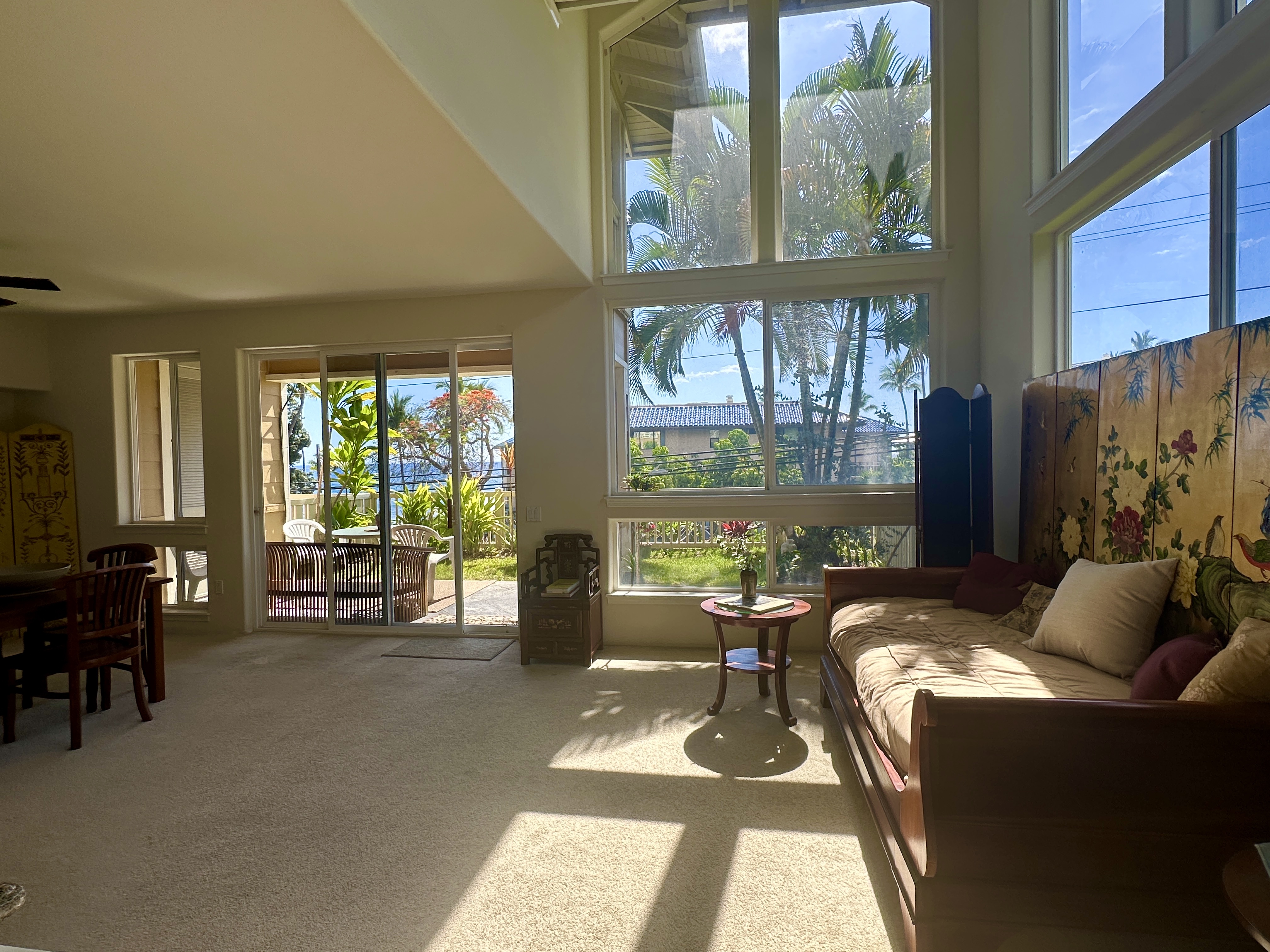 a living room with furniture and large windows