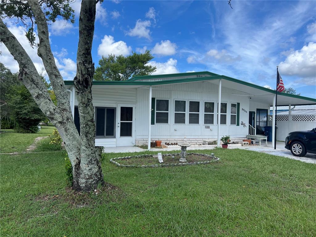 a view of a house with a yard porch and sitting area