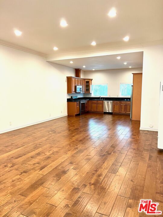 a view of kitchen and hall with wooden floor