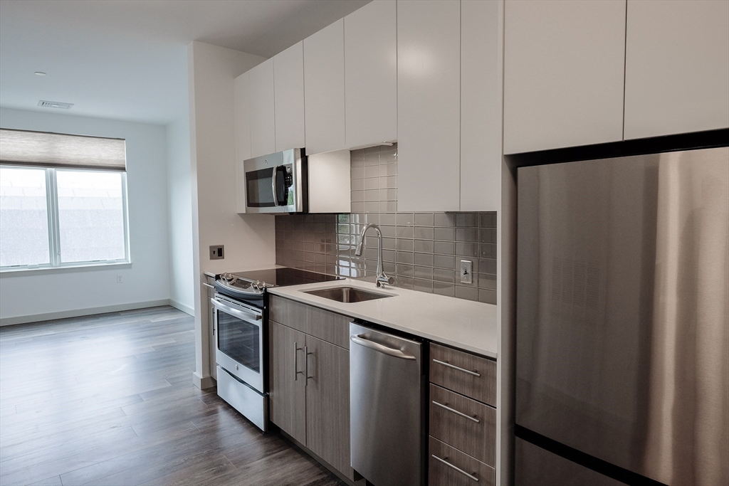 a kitchen with a stove and a refrigerator