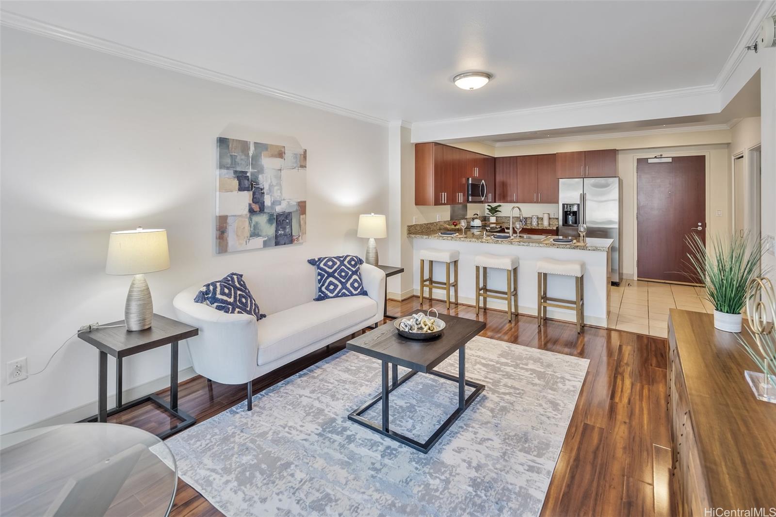 a living room with furniture and a wooden floor