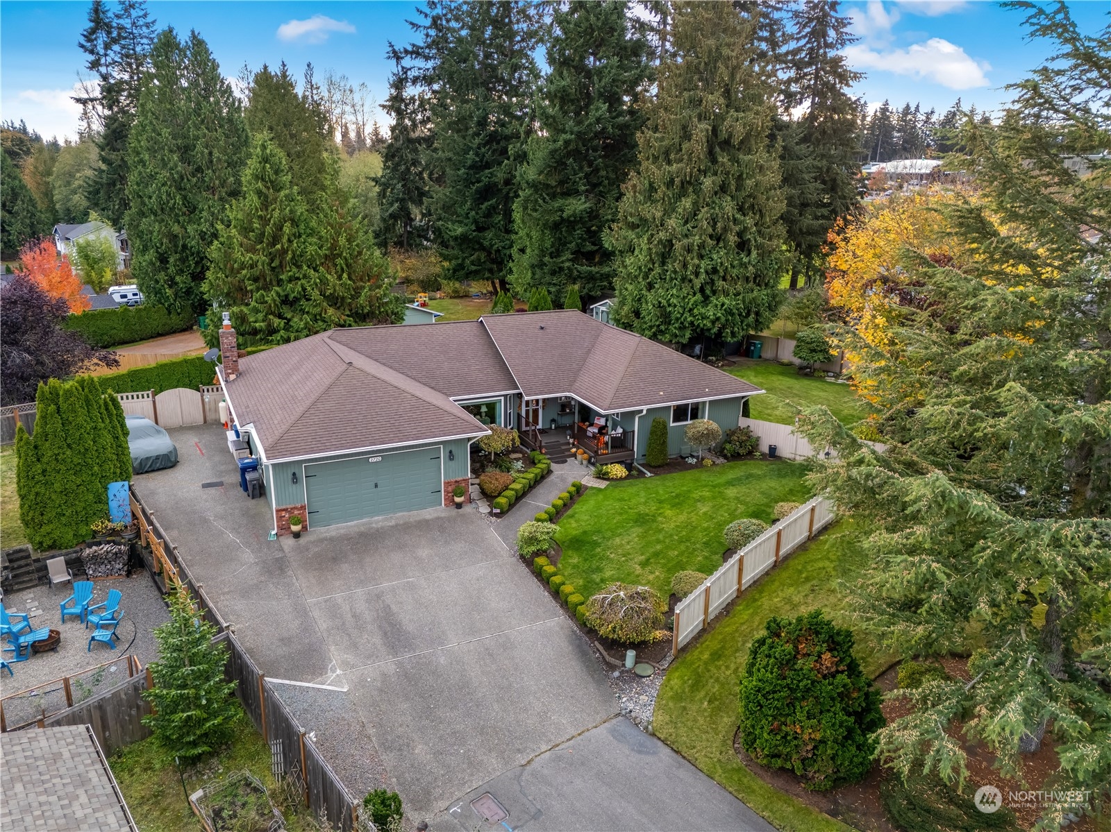 an aerial view of a house with swimming pool and garden