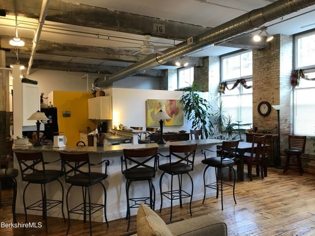 a room with lots of wooden furniture and a chandelier