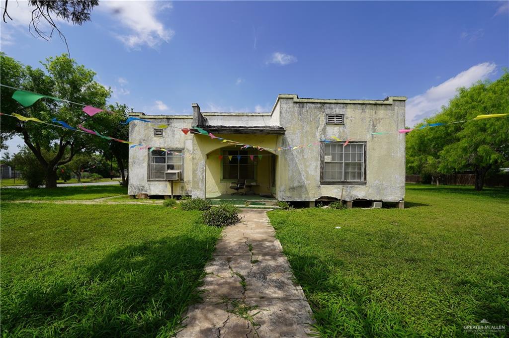 a front view of a house with a garden