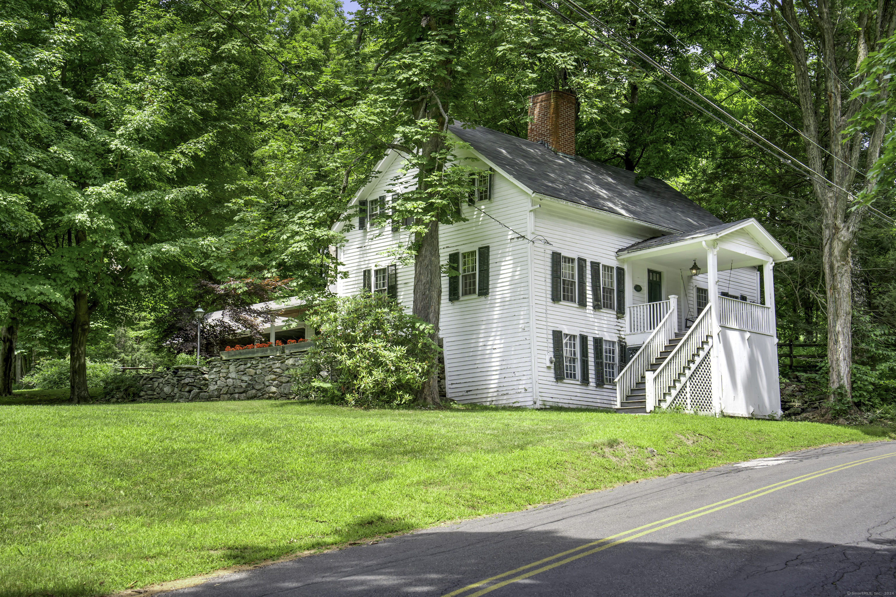 a front view of house with yard and green space