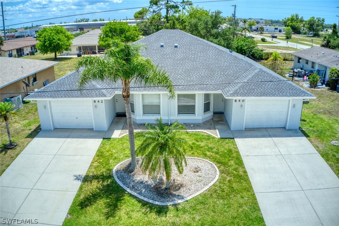 a aerial view of a house with a yard and potted plants