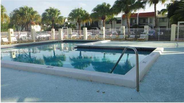 a swimming pool view with a outdoor seating