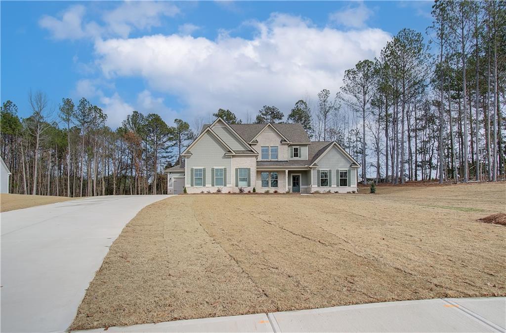 a front view of a house with a yard and mountain view