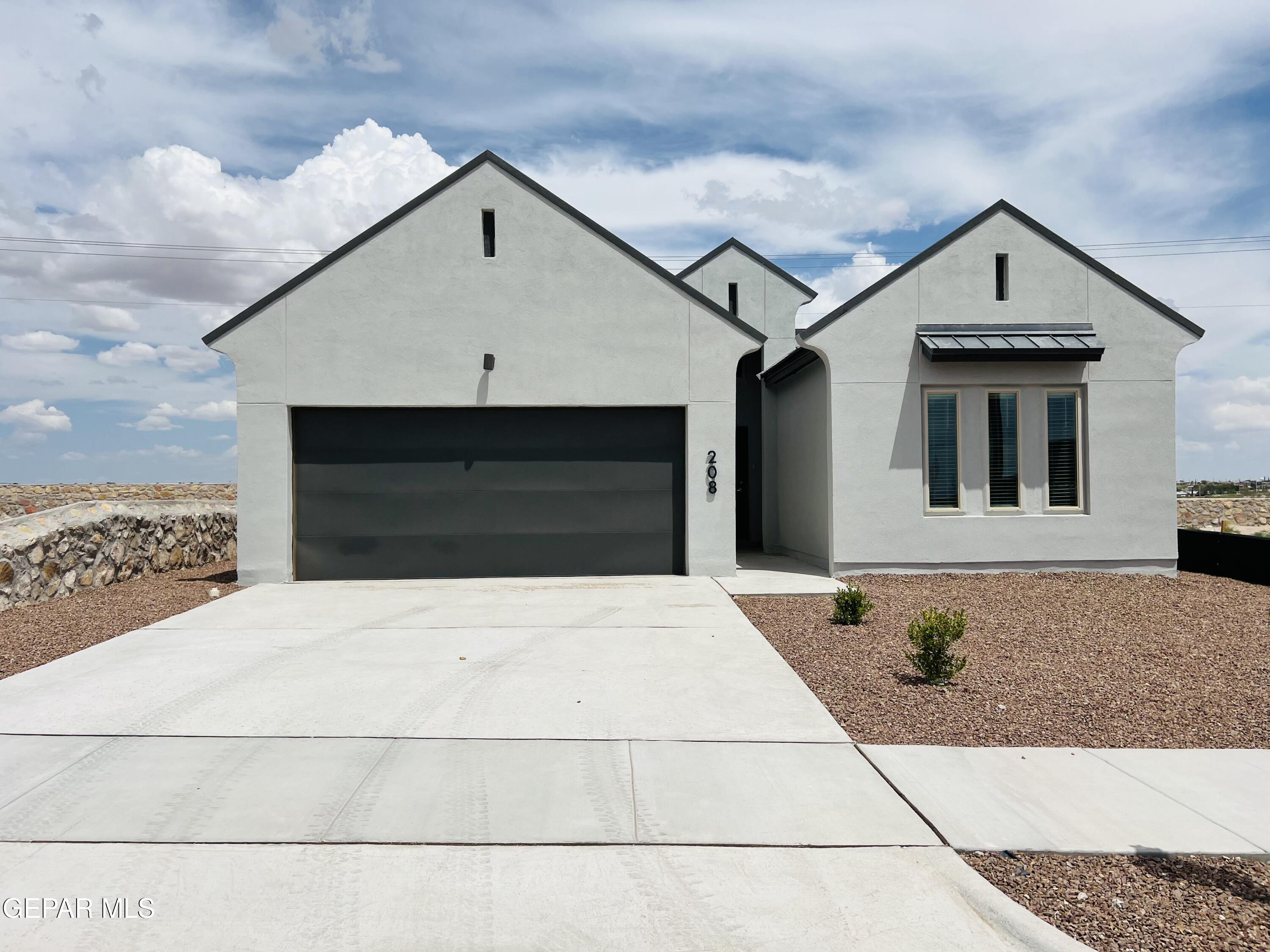 a front view of a house with garage