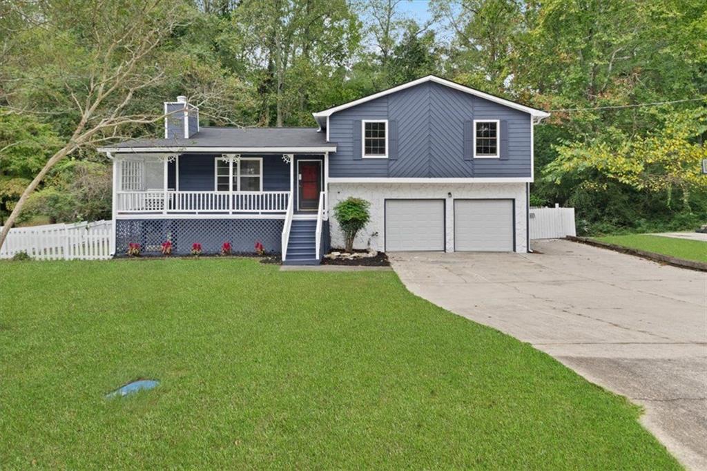 a front view of house with yard and green space